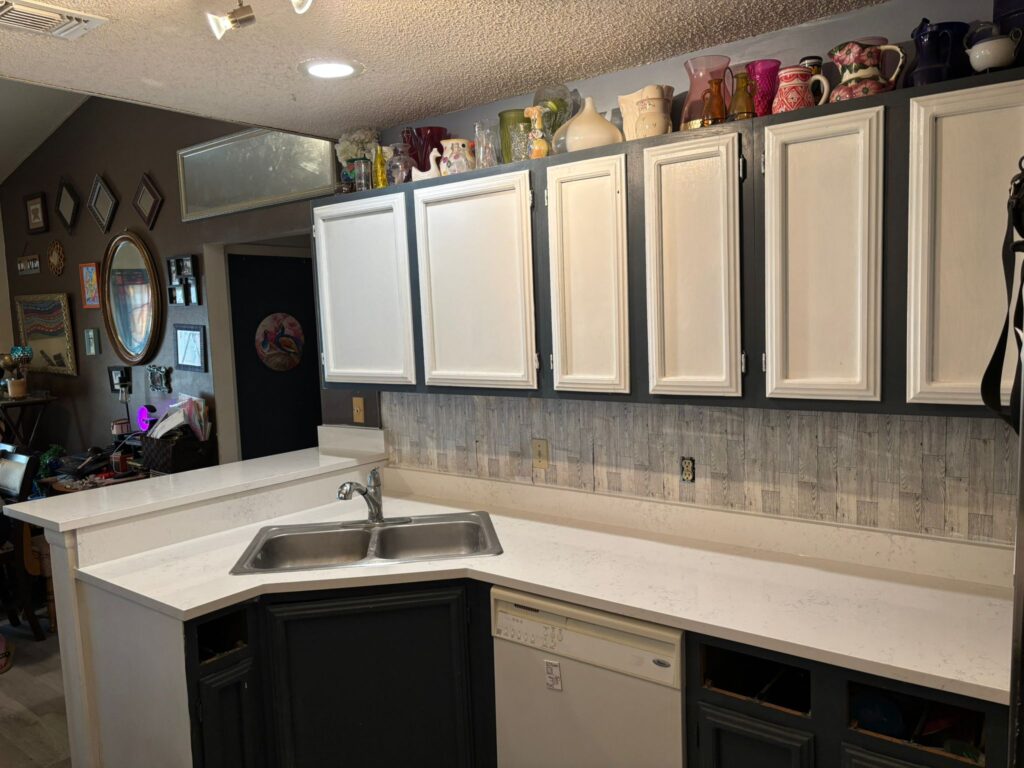 a kitchen with white cabinets and white counter tops